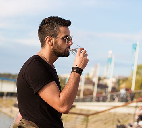 Young man drinking water